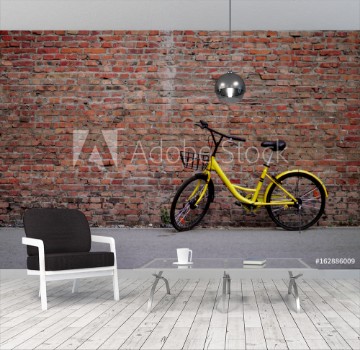 Picture of Yellow Bicycle by the Brick Wall